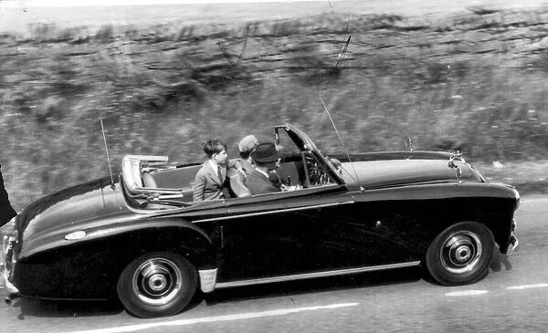 Queen Elizabeth II and The Duke of Edinburgh with Prince Charles driving in their car