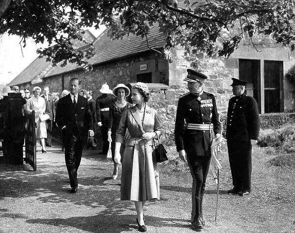 Queen Elizabeth II and the Duke of Northumberland followed by Prince Philip