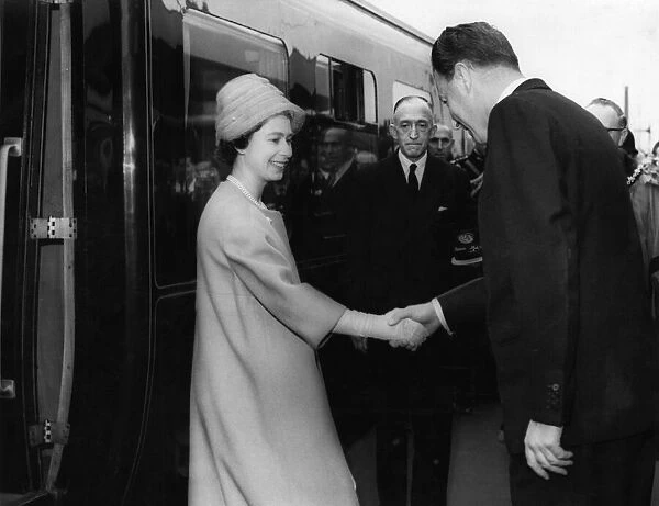 Queen Elizabeth II is greeted by Lord Derby as she leaves the Royal Train at Shaw Street