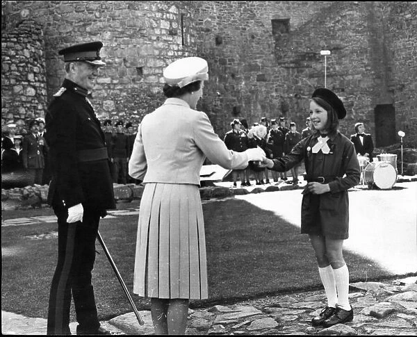 Queen Elizabeth II greets a member of the local brownies, at Harlech Castle, Llandudno