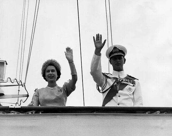 Queen Elizabeth II and her husband Prince Philip, Duke of Edinburgh wave goodbye on their