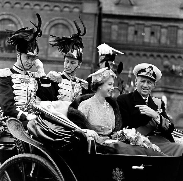 Queen Elizabeth II and King Frederick IX ride through the streets of Copenhagen