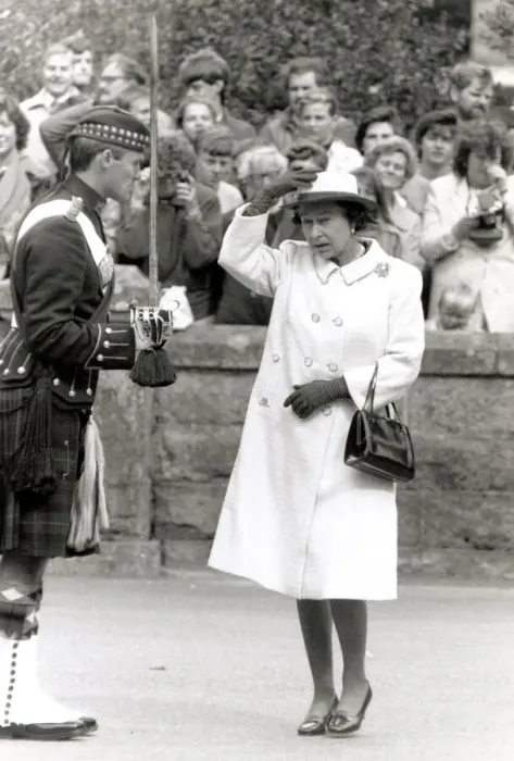 Framed Print : Queen Elizabeth II looking scared and gormless Holding hat on head Chatting Framed Print : Queen Elizabeth II looking scared and gormless Holding hat on head Chatting