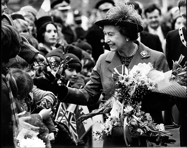 Queen Elizabeth II meets the happy crowd on her walkabout after opening the Delyn Borough