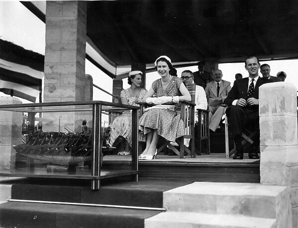 Queen Elizabeth II and Prince Philip seated in the pavilion at Port Harcourt watching a