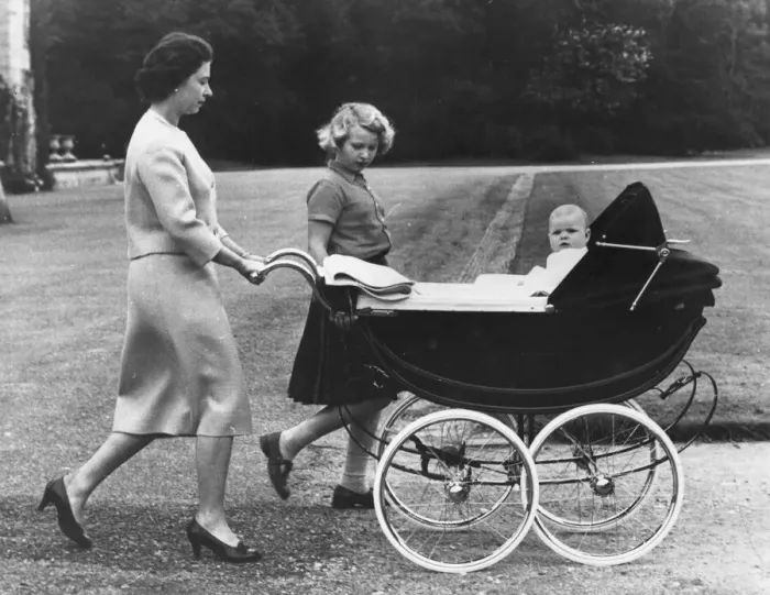 Framed Print : Queen Elizabeth II and Princess Anne take baby Prince Andrew for a ride in his high pram Framed Print : Queen Elizabeth II and Princess Anne take baby Prince Andrew for a ride in his high pram