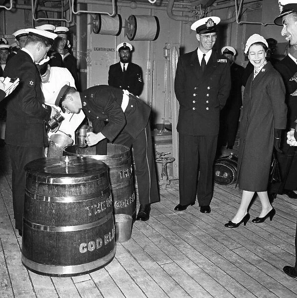 Queen Elizabeth II watches Victualling Officer B. R. Hailstone issuing the rum ration