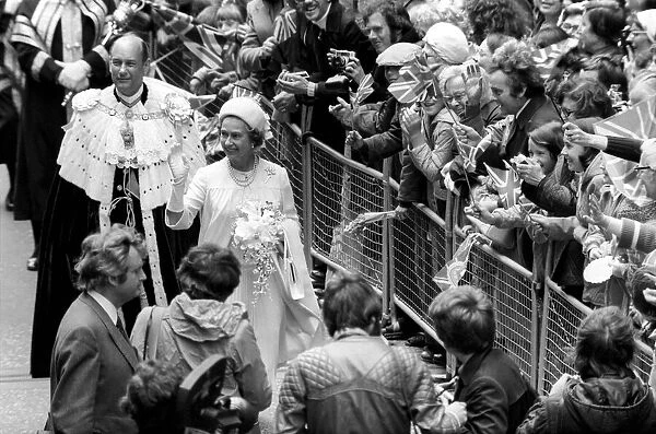 Queen Elizabeth II waving at the crowd during their Silver Jubilee celebrations