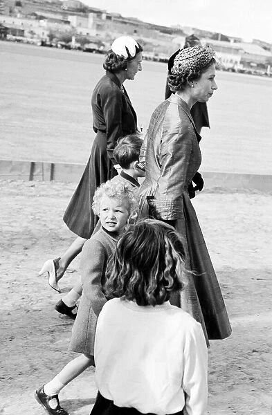 Queen Elizabeth ll May 1954 walking with Princess Anne while Prince Charles walks with