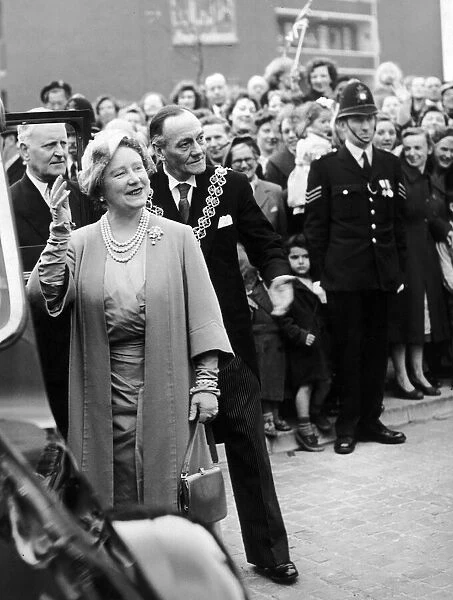 Queen Elizabeth the Queen Mother waves to crowds accompanied by the Lord mayor as she