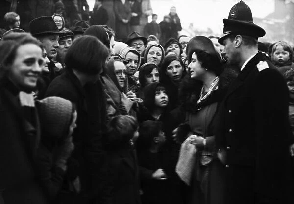 Queen Elizabeth watched by her husband King George VI, talks to a group of people made
