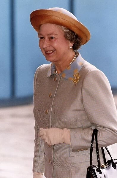 Queen Elizabeth wearing light brown suit and hat, arrives at the Guildhall in London
