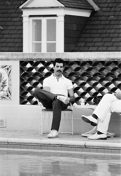 Queen lead singer Freddie Mercury seen here beside the swimming pool at their