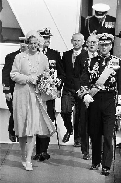 Queen Margrethe of Denmark, accompanied by her husband, Prince Henrik