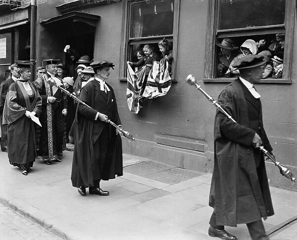 Queen Mary receives a degree of D. C. L. at Oxford University walking alongside the queen