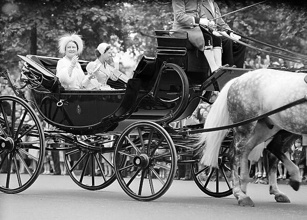 The Queen Mother, Princess Margaret and Princess Anne travel in an open top carriage at