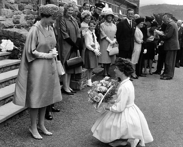The Queen is presented with a bouquet of flowers at the U. D. C offices. 10th August 1963