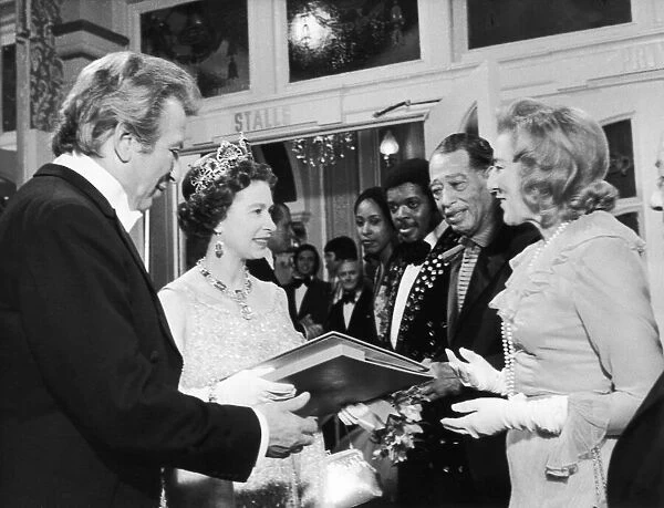 The Queen is presented with a record by singer Vera Lynn. 26th November 1973
