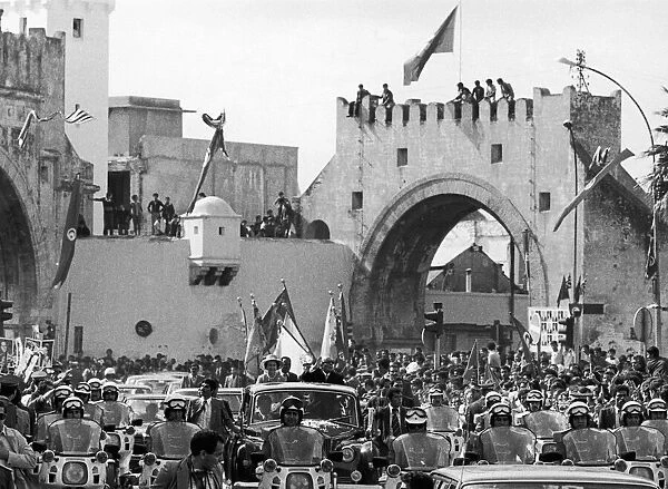 The Queen and President Bourguiba pass a Morrish arch during a drive through Tunis