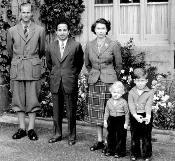 The Queen and Prince Philip with Prince Charles and Princess Anne pose with King Feisal