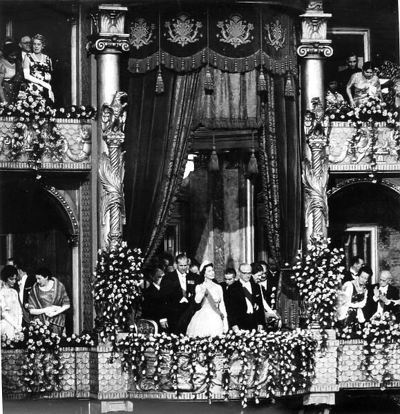 THE QUEEN AND PRINCE PHILIP WAVING FROM ROYAL BOX WHILE ATTENDING THE THEATRE DURING A