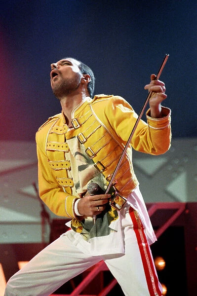 Queen rock group performing. Singer Freddie Mercury on stage