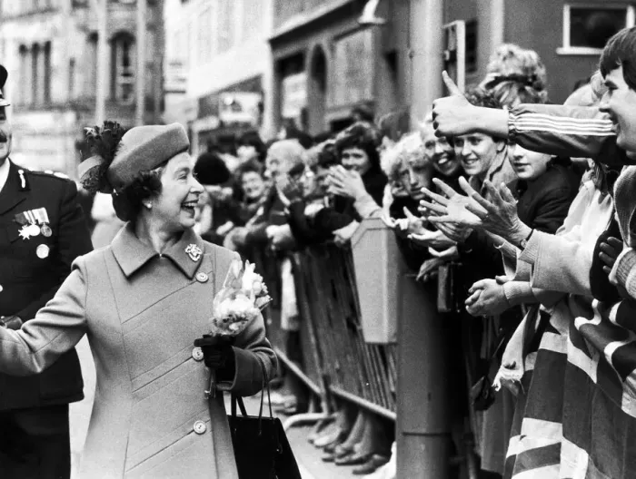 Framed Print : The Queen visits Manchester. The Queen laughs as she is greeted by the crowd Framed Print : The Queen visits Manchester. The Queen laughs as she is greeted by the crowd