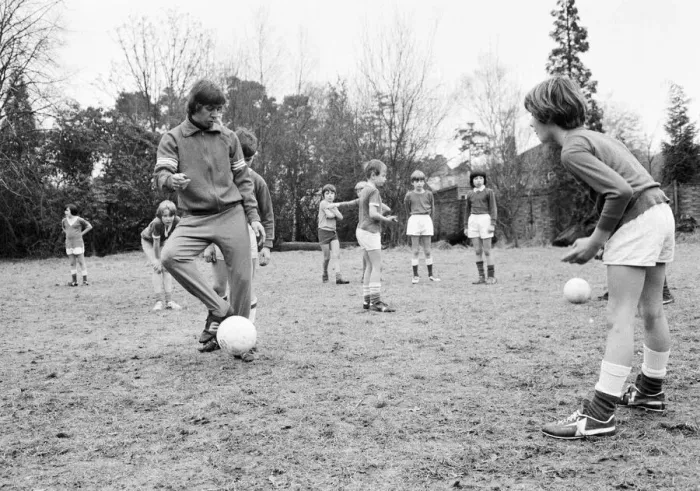Framed Print : Queens Park Rangers footballer Don Masson coaching children to play football at the Our Framed Print : Queens Park Rangers footballer Don Masson coaching children to play football at the Our