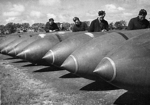 R. A. F. armourers working with 12, 000 lb bombs. Lancaster Bombers have been