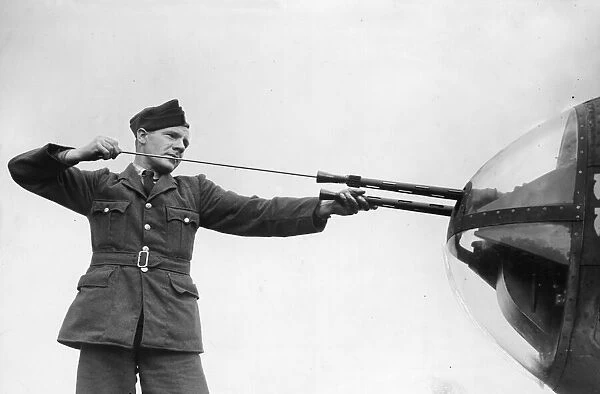 R. A. F. ground crew clean the guns of a bomber. Pilots are ready to praise