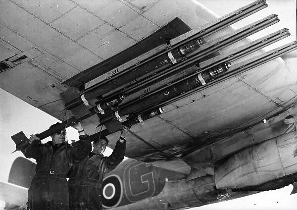 R. A. F ground crew equipping Beaufighters with rocket projectiles
