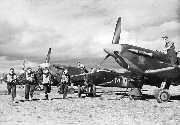 R. A. F. pilots scramble to waiting Spitfires. The Supermarine Spitfire is a