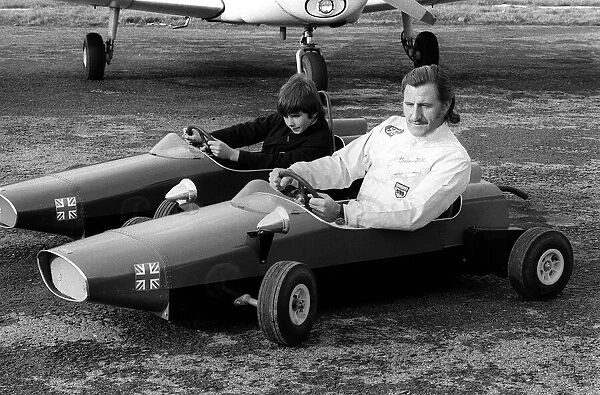 Racing driver Graham Hill races son Damon in their toy cars, at Elstree aerodrome 1971