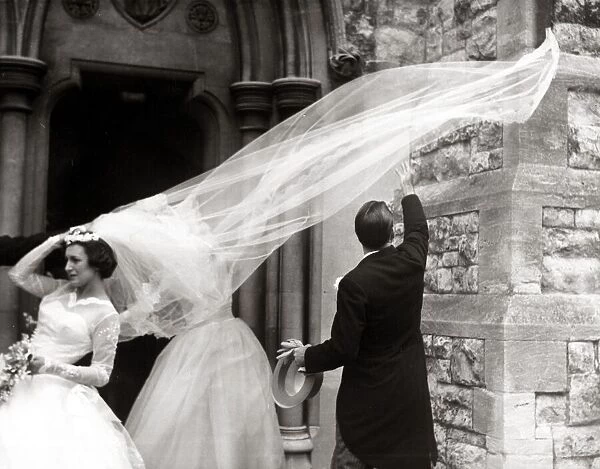 Racing driver Jack Brabham tries to catch the bride