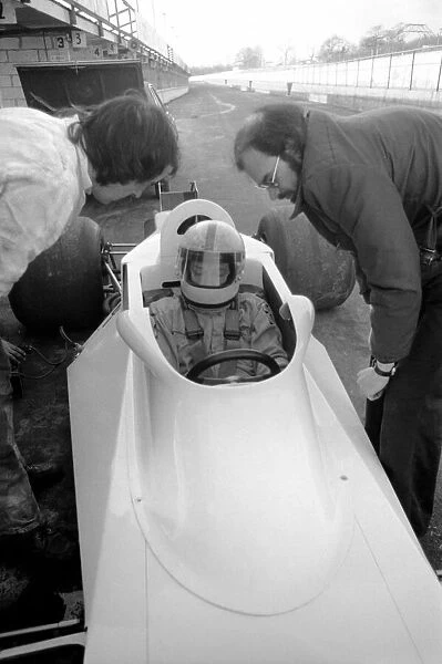 Racing driver John Surtees trying his new car. January 1976 76-00088-004