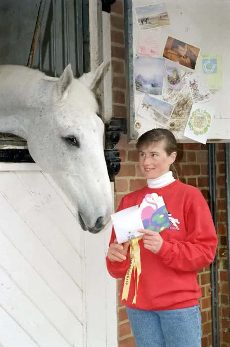 Framed Print : Racing Legend Desert Orchid being read his fan mail by stable girl Janice Coyle