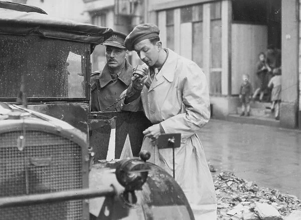 A radio correspondant speaking into his micrphone as he reports from the front in France