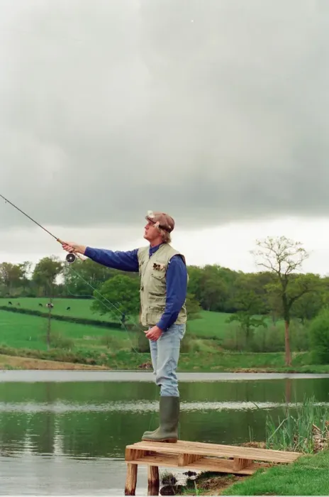 Framed Print : Radio Disc Jockey Chris Tarrant enjoying a spot of fishing in his spare time