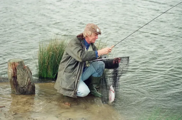 Framed Print : Radio Disc Jockey Chris Tarrant enjoying a spot of fishing in his spare time