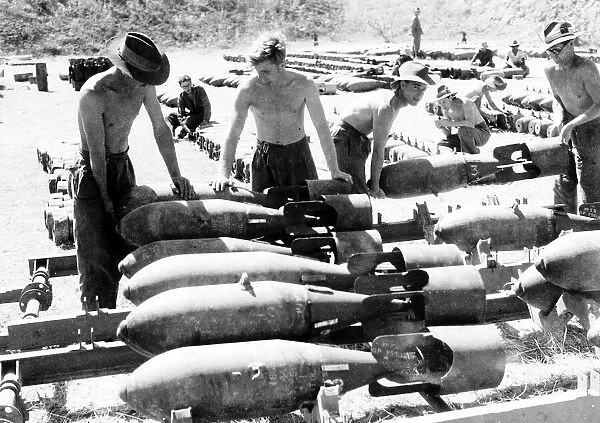 RAF ground crew in Burma loading 250lb bombs on to loading trolleys at an advanced