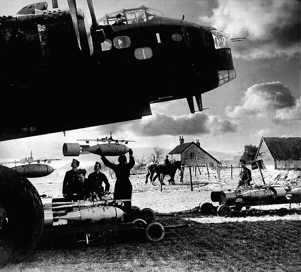 RAF ground crew loading bombs onto a Stirling bomber before a raid during World War Two