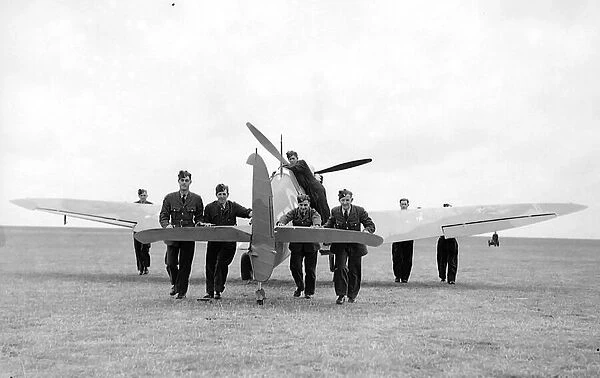 RAF ground crew push back a damage aeroplane to the hanager during th Battle of Britain