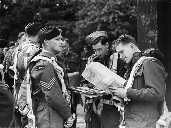 The RAF having landed, inspecting their maps. Picture taken 6th June 1943