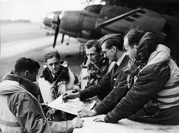 The RAF, (location unknown) studying their maps. Picture taken 13th June