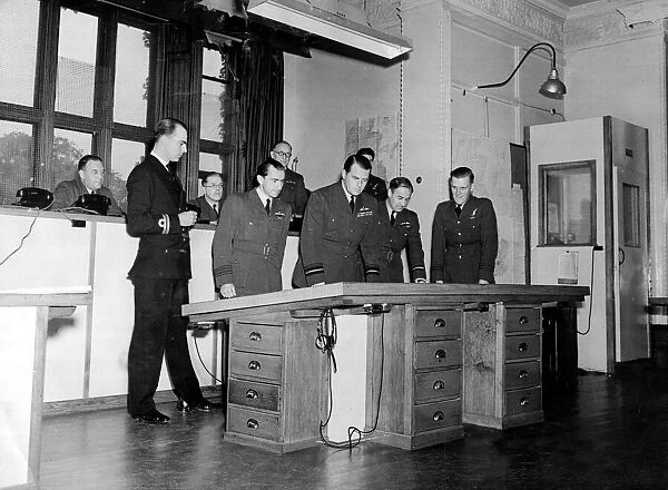 RAF officers study intelligence reports and maps as they plan a large scale bomber