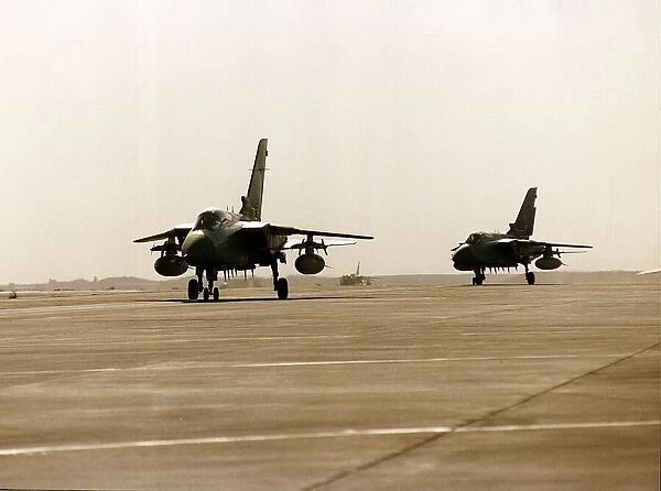 Two RAF Panavia Tornado F3 fighter planes used in the Gulf War taxi along runway
