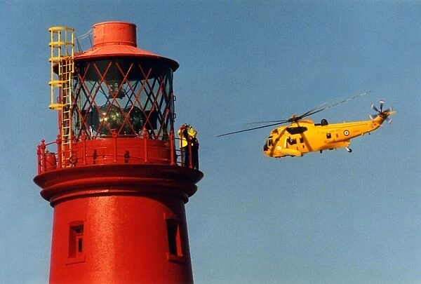 A RAF search and rescue Sea King helicopter from RAF Boulmer flies past the Longstone