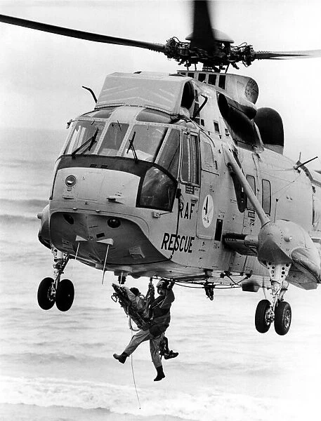 A RAF search and rescue Sea King helicopter from RAF Boulmer winches a casualty aboard
