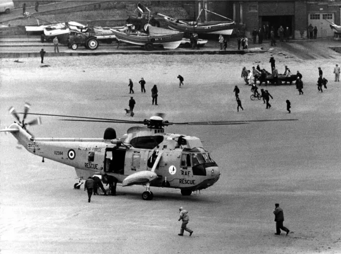 Framed Print : A RAF search and rescue Sea King from RAF Boulmer lands a man on the beach after he was
