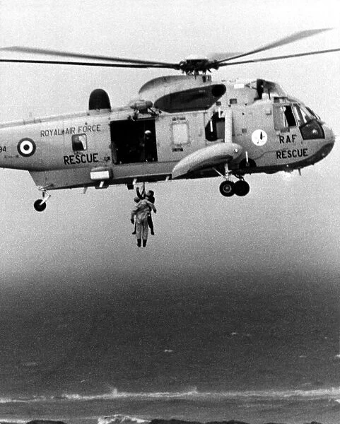 A RAF search and rescue Sea King from RAF Boulmer winches a man onboard plucking him out